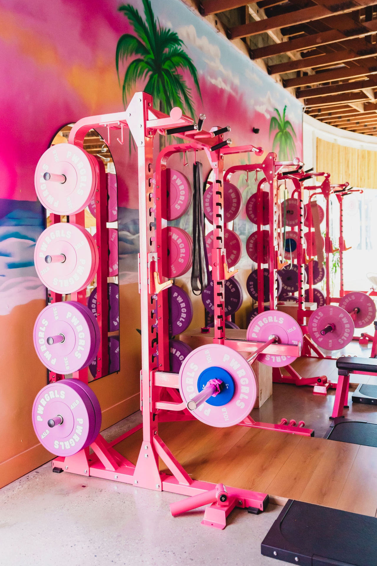 Member squatting at pink rack